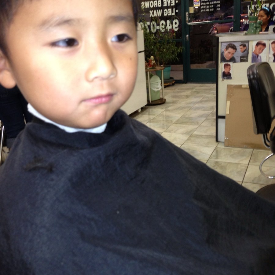 Francis Ruan as a small boy in a barber chair