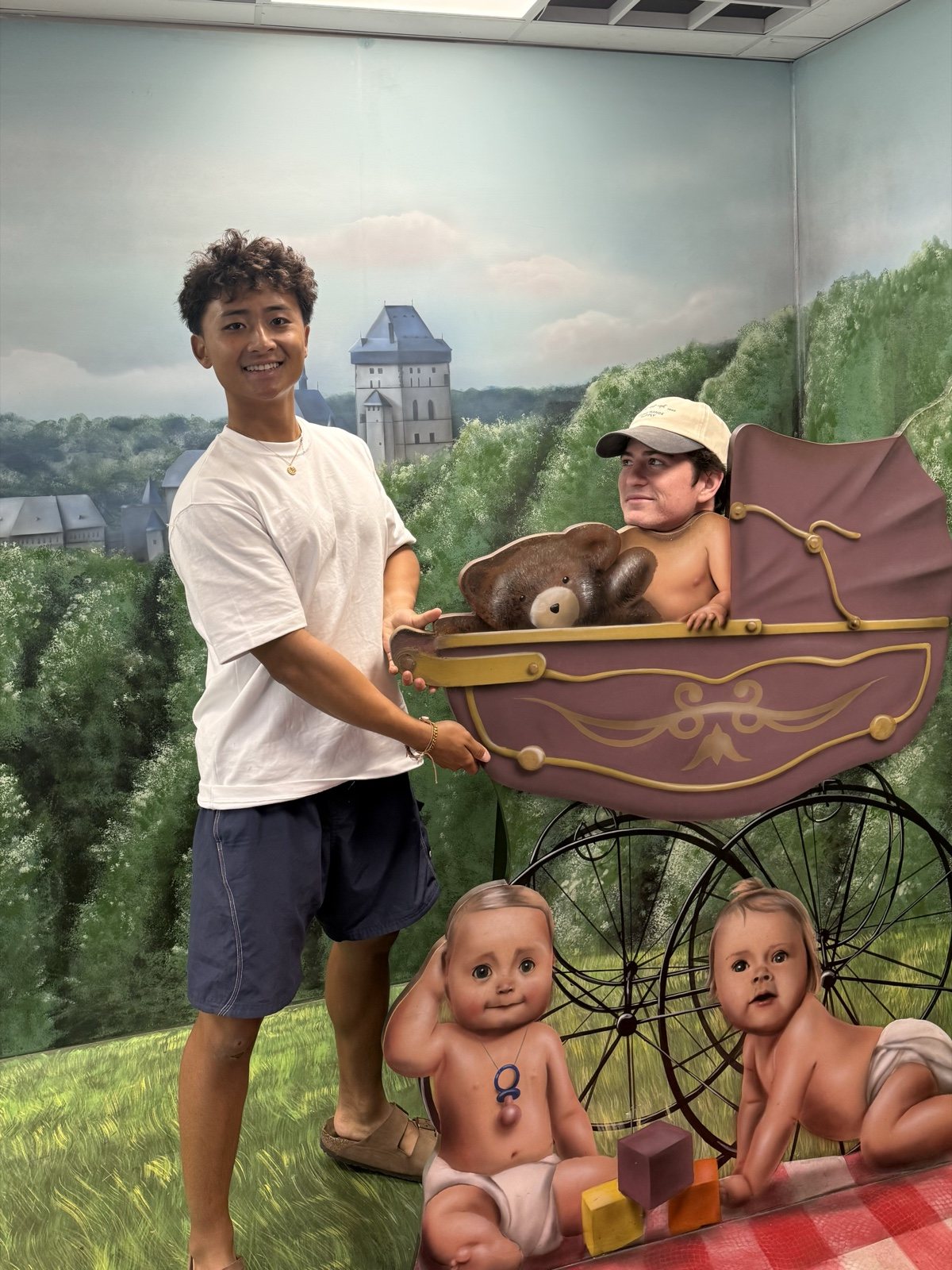 Francis Ruan and a friend behind a painted carnival cutout