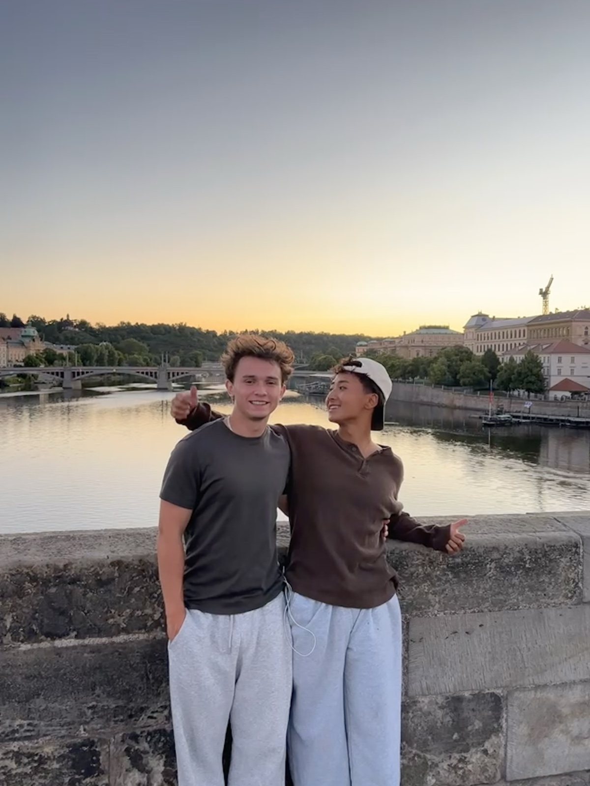 Francis Ruan and a friend on a bridge in Prague at sunset