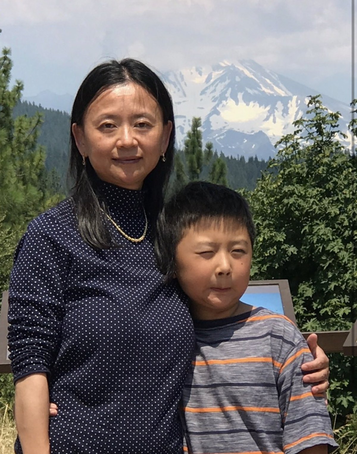 Francis Ruan as a boy with his mother, a mountain behind them